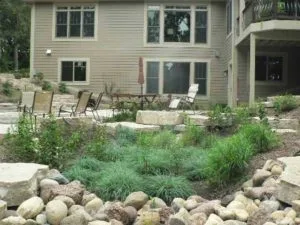 The benefits of a rain garden- Variety of grasses in rain garden in front of house