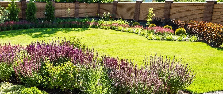 Landscape in North Shore, WI, with flowers around a green lawn.