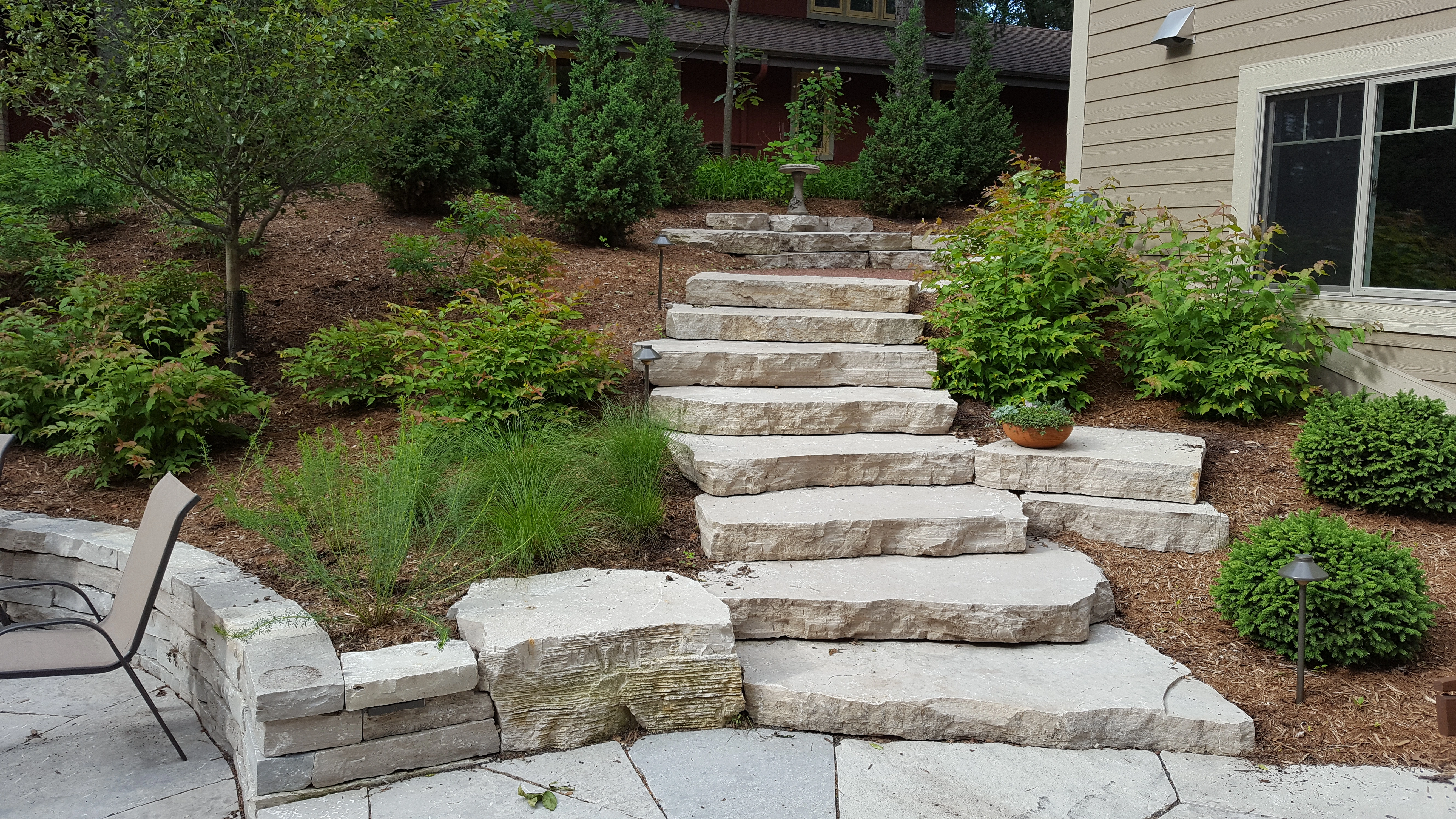 Outdoor steps in Milwaukee, WI, by a retaining wall.