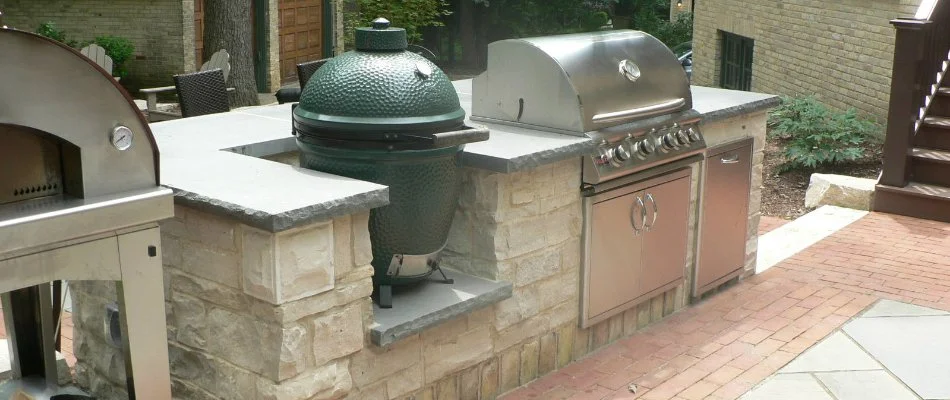 Outdoor kitchen with grill and green egg on a property in Wauwatosa, WI.