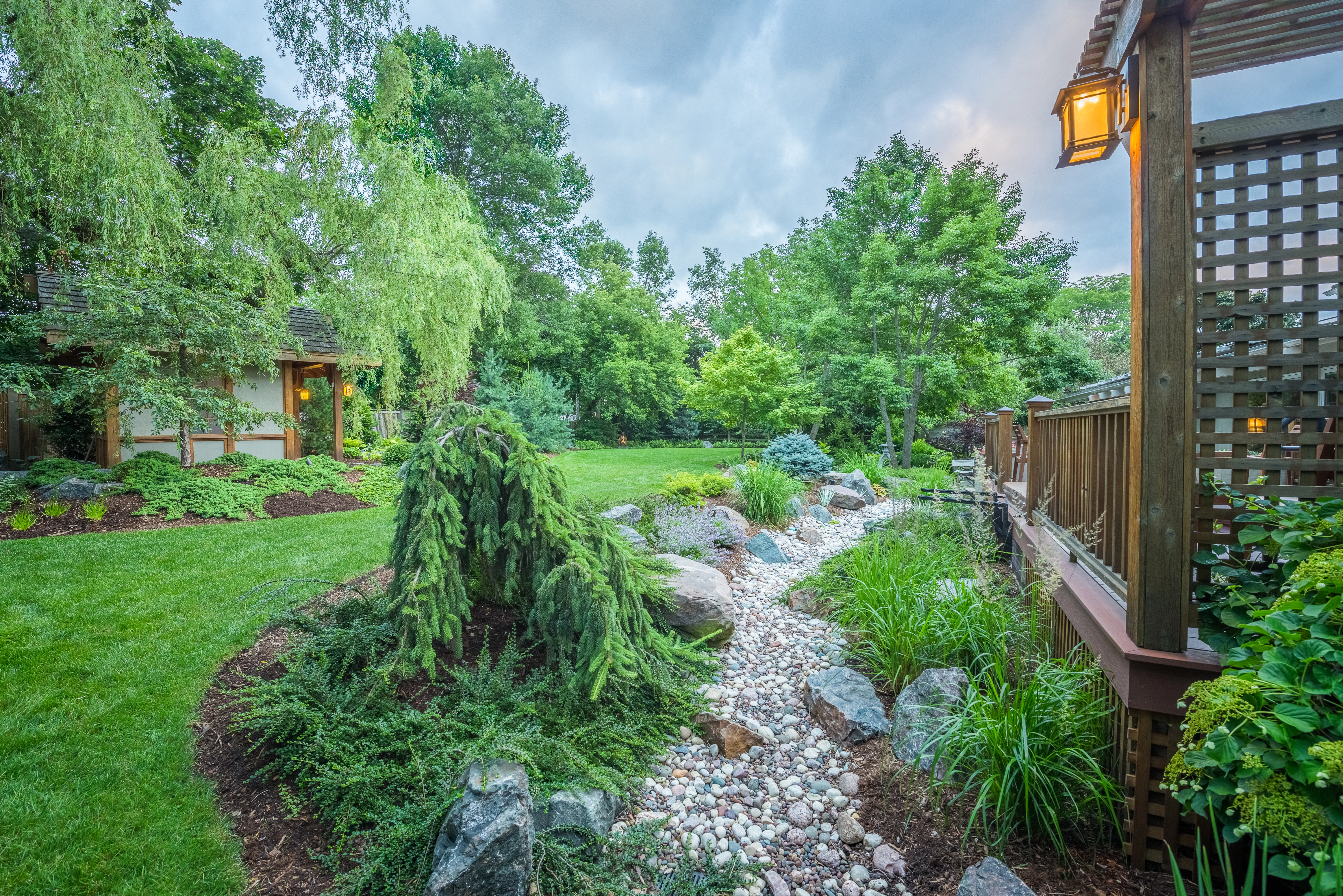 A dry creek bed in Milwaukee, WI, with small plants and rocks.