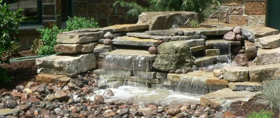 Large rock water feature on property in Milwaukee, WI.