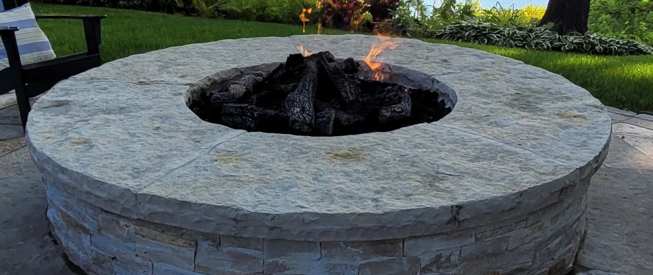 A fire pit next to a lake.