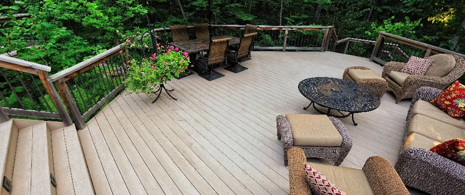 Deck outside a house in Milwaukee, WI, with tables, chairs, and potted plants.