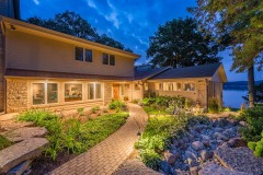 Large house and paved walkway with lighting
