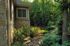 Buff Outcropping Stone next to house