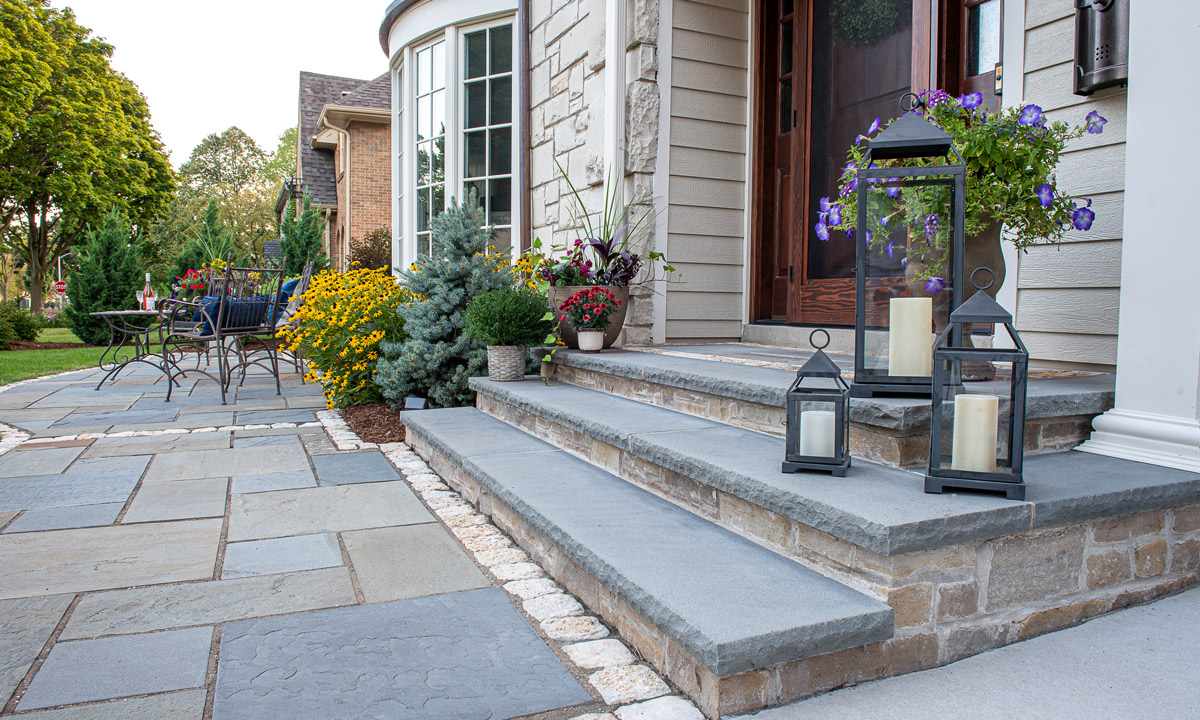 Stone pavers and stairs outside of a house