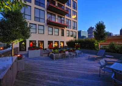 Apartment building next to decked seating area