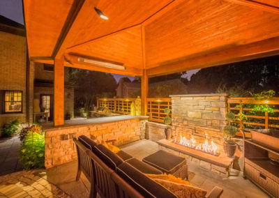 Firepit and outdoor furniture under covered pergola