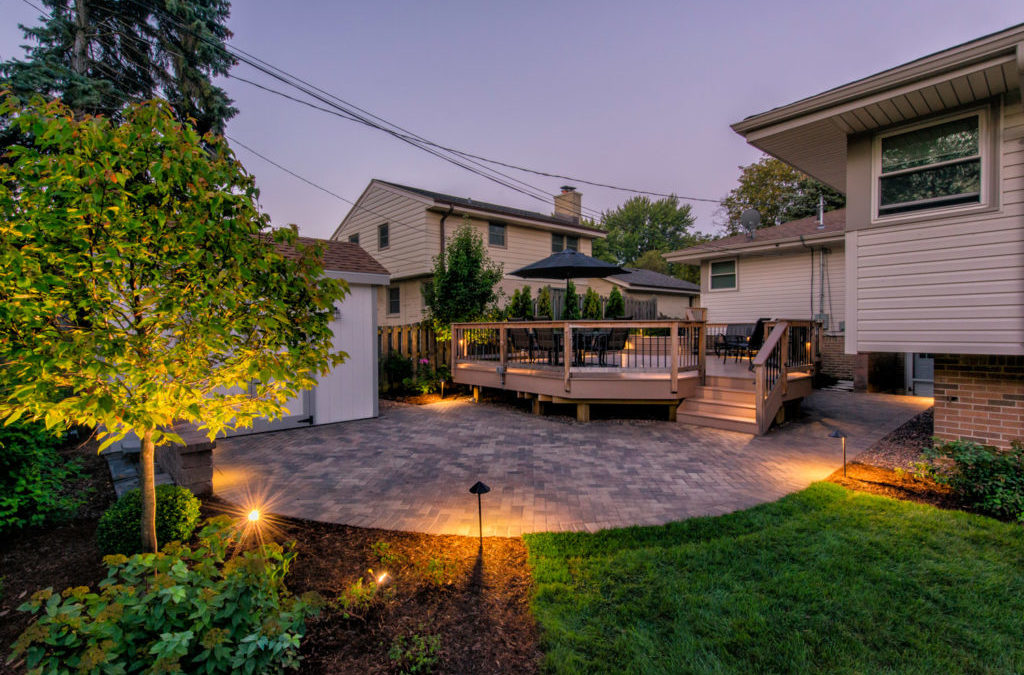 Landscaping Trend For 2023 Cover Image Decked backyard with paver patio
